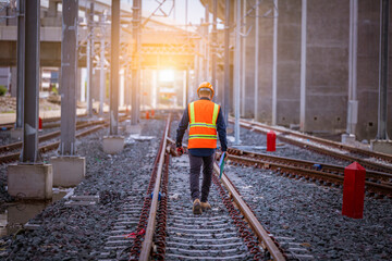 Wall Mural - Engineer under inspection and checking construction process railway switch and checking work on railroad station .Engineer wearing safety uniform and safety helmet in work.