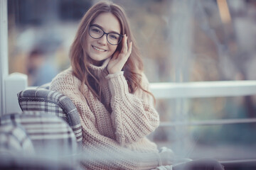 Wall Mural - happy girl autumn cafe sweater concept vision model with glasses posing