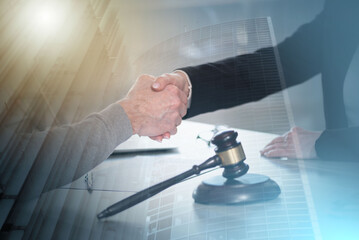 Handshake between female lawyer and male client; multiple exposure