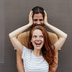 Wall Mural - Laughing happy attractive young couple