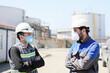 © Funtay - Workers are talking with protective masks for coronavirus (covid-19) epidemic in the construction field. In humans, coronaviruses cause respiratory tract infections that can range from mild to lethal.