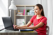 © Syda Productions - children, education and learning concept - happy smiling teenage student girl with laptop computer at home