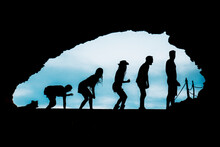 Silhouette Of A Group Of Friends With Dog In A Cave In Ibiza. Human Evolution And Fun
