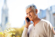 © mimagephotos - Close up handsome older man talking with cellphone outside