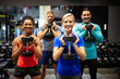 © NDABCREATIVITY - Group of sportive people in gym. Happy fit friends workout, exercise in fitness club