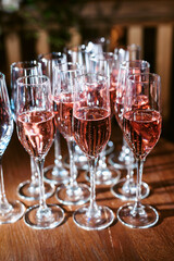 Set or row glasses of wine on the table before reception or wedding party