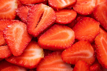 Wall Mural - Closeup of juicy sliced strawberries on background