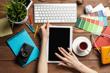 Freelancer sitting at desk and tablet computer