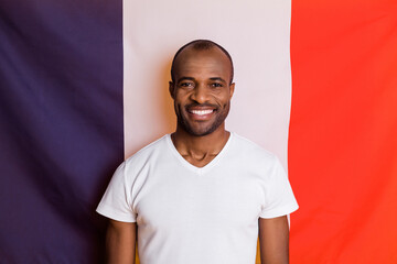 Close-up portrait of his he nice attractive content cheerful cheery guy student exchange program relocation move immigrant isolated over french national flag background