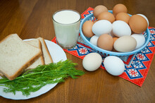 Chicken Eggs On A Plate With A Glass Of Milk, Dill, Several Slices Of White Bread On A Red Napkin On A Kitchen Wooden Table. Breakfast Eggs. Natural Protein.