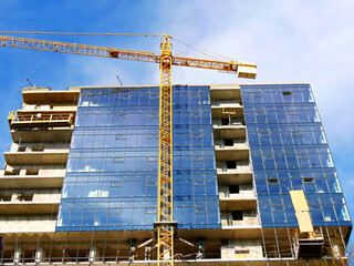 Wall Mural - Building under construction. Construction site. Crane near building.