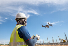Construction Engineer Man Flying Drone Over Construction Site
