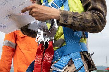 Wall Mural - Construction worker wearing safety harness at construction site