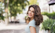 Beautiful happy young woman closeup portrait. Pretty model girl with perfect fresh clean skin smiling outdoors. Beauty, summer fun, enjoy life, people concept