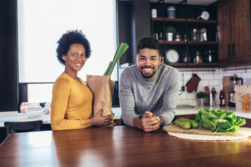 Happy african-american couple together in their kitchen at home