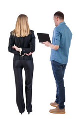 Poster - Back view of business woman and business man in suit with laptop.