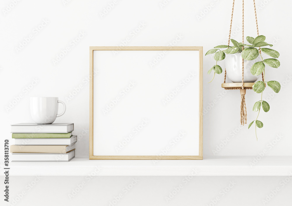 Interior poster mockup with square wooden frame on the shelf with green ...