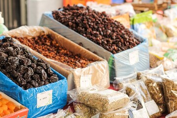 Poster - Selective focus shot of dried fruits and nuts in an outdoor market