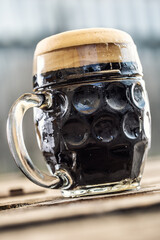 Wall Mural - A mug of dark beer with foam