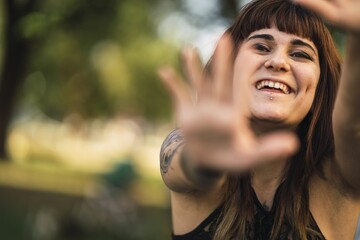 Poster - Closeup shot of a young attractive Caucasian female with tattoos making a cute face