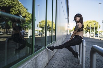 Sticker - Young attractive Caucasian female with tattoos in the street