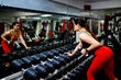© 4otograf - Girl in the gym. Goes in for sports, on exercise machines
