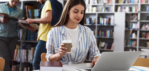 Poster - Young student with laptop at table in modern library. Banner design