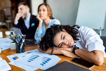 Depressed Lady Resting Head On Hands During Meeting In Office