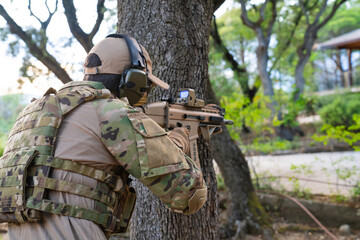 United States Marine with his assault rifle. Airsoft gunner with his assault rifle. Man having fun playing airsoft. Marine doing target practice. Weapons for war. Soldier. Marine. Airsoft.