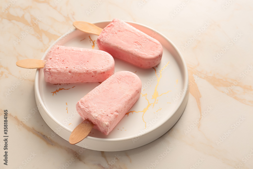 Plate with tasty strawberry ice cream on light background