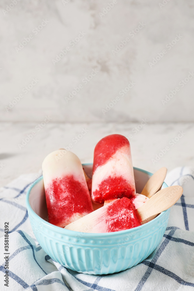 Bowl with tasty strawberry ice cream on table
