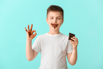 Sticker - Cute little boy with chocolate showing OK on color background