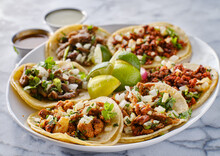 Platter Of Mexican Street Tacos With Carne Asada, Chorizo, And Al Pastor In Corn Tortillas