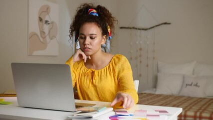 Sticker - African-American designer working on laptop at home