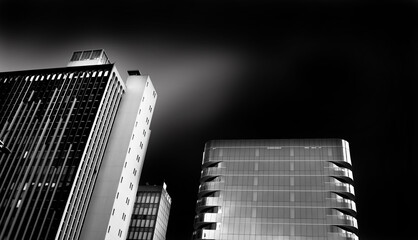 black and white buildings with dark sky