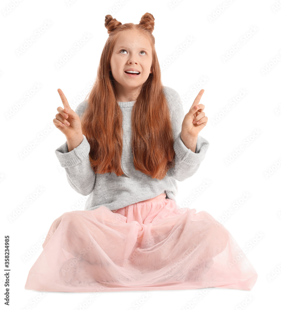 Cute redhead girl showing something on white background