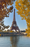 Fototapeta Boho - eiffel tower in paris between yellow foliage in autumn view from seine river