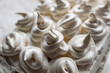 © Анна Иванова - Cream dessert of airy Italian meringue. Whipped egg whites with hot sugar syrup. Light delicate cake cream in the form of a twisted peak on the top of the head in a spiral
