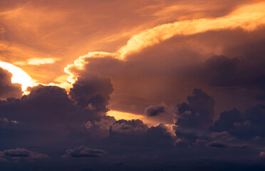 sunset sky. golden light shine in layers of clouds. fluffy clouds at dusk. twilight sky. god light. 