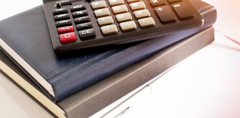 Poster - Calculator pen and notebook on white background