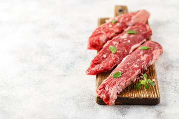 Wall Mural - Raw steak with spices on wooden cutting board