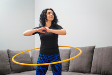 Woman Rotating Hula Hoop. Girl Training At Home. Healthy Sporty Lifestyle.