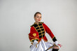beautiful girl in a red antique hussar costume posing on a white background