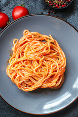 spaghetti pasta tomato sauce
serving size second course. food background top view copy space