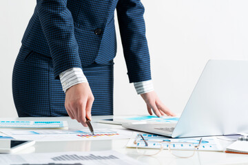 Wall Mural - Woman standing near office desk with laptop