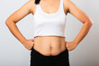 © sorapop - Close up of Asian mother woman showing stretch mark loose lower abdomen skin she fat after pregnancy baby birth, studio isolated on white background, Healthy belly overweight excess body concept