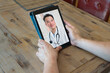 © romylee - telemedicine on a mobile device against a wooden background