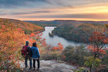Hikers At A Beautiful Overlook In The Fall At Sunset