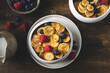 Trendy homemade breakfast, pancake cereal, mini pancakes with berries, top view