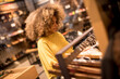 © BGStock72 - Young black woman with curly hair in shopping